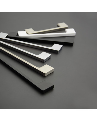 Tirador de mueble TECHNO tirador de diseño colocado sobre una superficie gris