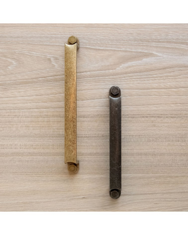 Tirador de mueble DUBLIN tirador de diseño dispuesto verticalmente sobre un panel de madera clara