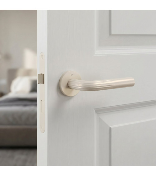 Manija de puerta minimalista en zamak FRELLA redonda diseño