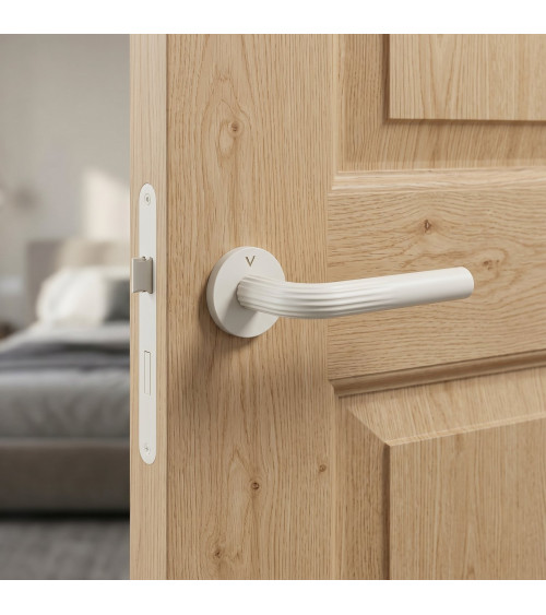Manija de puerta minimalista en zamak FRELLA redonda diseño