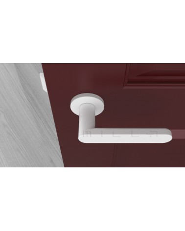 Maneta de puerta color blanco ALORA maneta de diseño vista desde arriba montada en una puerta