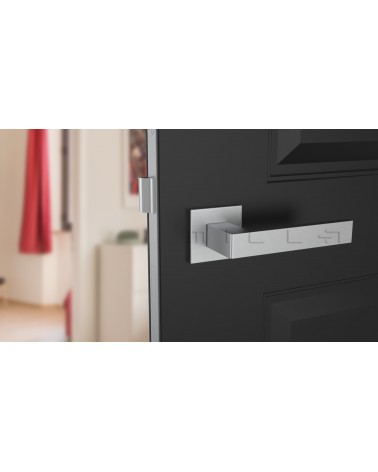 Manilla de puerta cromo satinado SULLA manilla de diseño vista frontal montada en una puerta