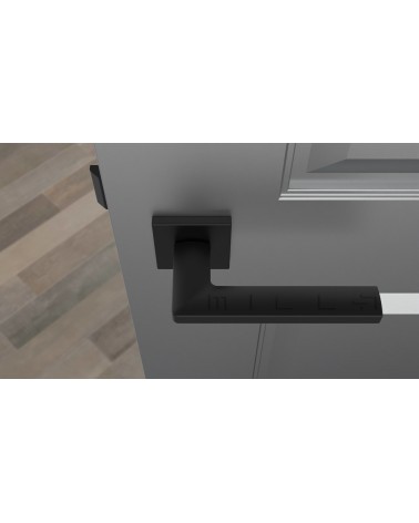 Tirador de puerta negra PYROLA herrajes de diseño vista superior montada en una puerta