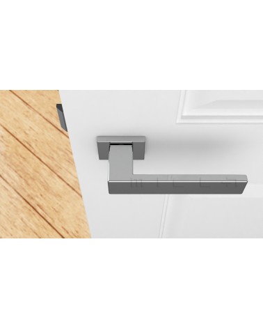Tirador de puerta PINA cromada pulida de diseño vista superior montada en una puerta