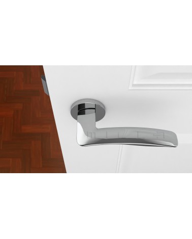 Tirador de puerta cromo pulido ROBINE ferretería de diseño vista superior montada en una puerta