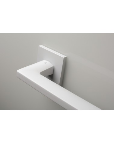 Palanca de puerta blanca PYROLA herraje de diseño vista ampliada de la palanca montada en una puerta