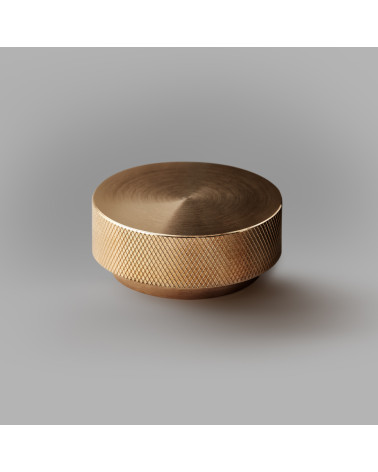 Botón de mueble oro mate TOVE tirador de diseño modelo grande sobre un fondo gris