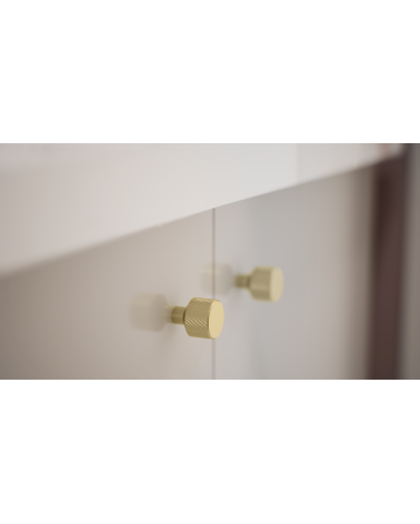 Tirador de mueble oro mate GRETA diseño fijado en un mueble