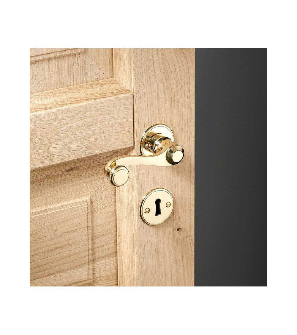 Conjunto manivela de puerta en latón sobre roseta redonda
