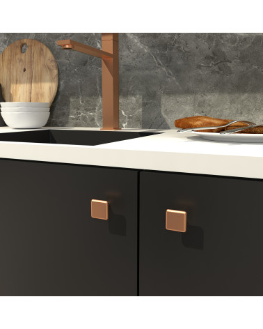 Botón de mueble cobre NOX tirador de diseño fijado en un mueble de cocina