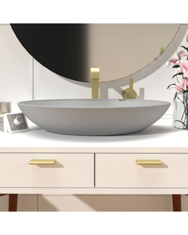 Tirador de mueble NOX-1 diseño dorado mate montado en un mueble de baño