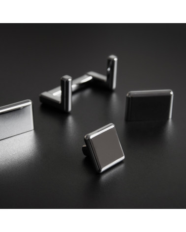 Botón de mueble titanio NOX tirador de diseño presentado sobre una superficie oscura